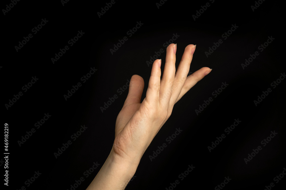Elegant young girl hand gesture isolated on a black background photo