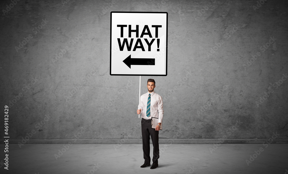 business person holding a traffic sign concept business person holding a traffic sign concept