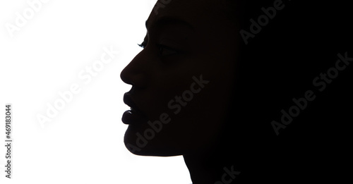 Black profile of an African woman on a white background, shaded silhouette of head. Proud woman face.