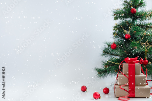 Blurred Christmas tree, gift boxes and balls. LSpace for design and text. Holidays, celebration and presents concept.