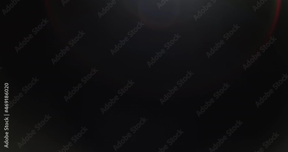 Two beautiful overlays of lens flares glowing on the black background. Slow motion. Two beautiful overlays of lens flares glowing on the black background. Slow motion.