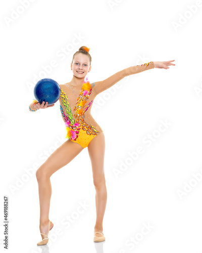 Girl gymnast performs exercises with the ball. photo