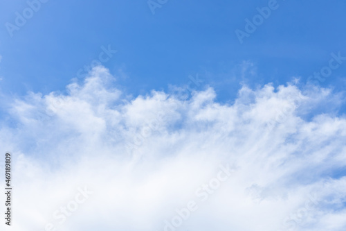 white fluffy clouds in the blue sky .blue sky background with tiny clouds