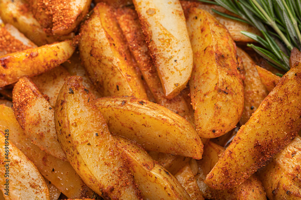 Fried potatoes with rosemary and spices, top view. Baked in the oven. Fried potatoes with rosemary and spices, top view. Baked in the oven.