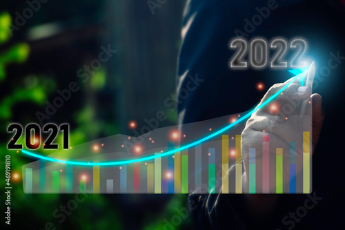 Business man pointing graph for success growing in to 2022.Graph to 2022 word for new year festival.card,happy,Vector concept luxury designs and new year celebration.