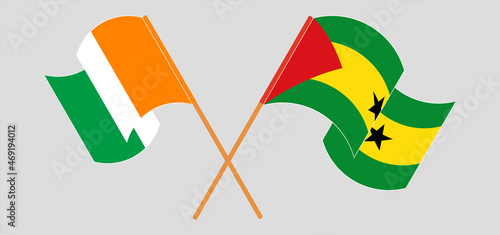 Crossed and waving flags of Republic of Ivory Coast and Sao Tome and Principe