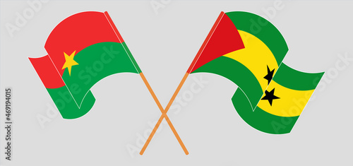 Crossed and waving flags of Burkina Faso and Sao Tome and Principe
