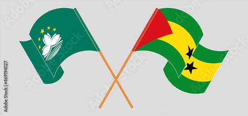 Crossed and waving flags of Macau and Sao Tome and Principe