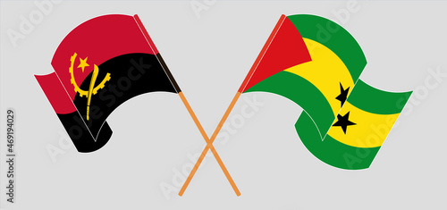 Crossed and waving flags of Angola and Sao Tome and Principe