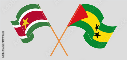 Crossed and waving flags of Suriname and Sao Tome and Principe