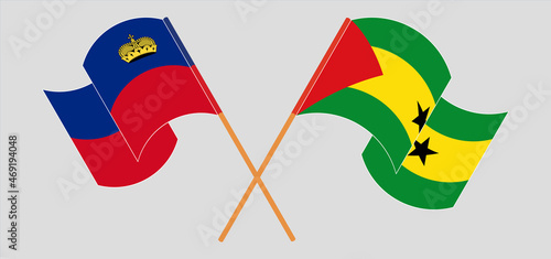 Crossed and waving flags of Suriname and Sao Tome and Principe
