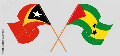 Crossed and waving flags of East Timor and Sao Tome and Principe