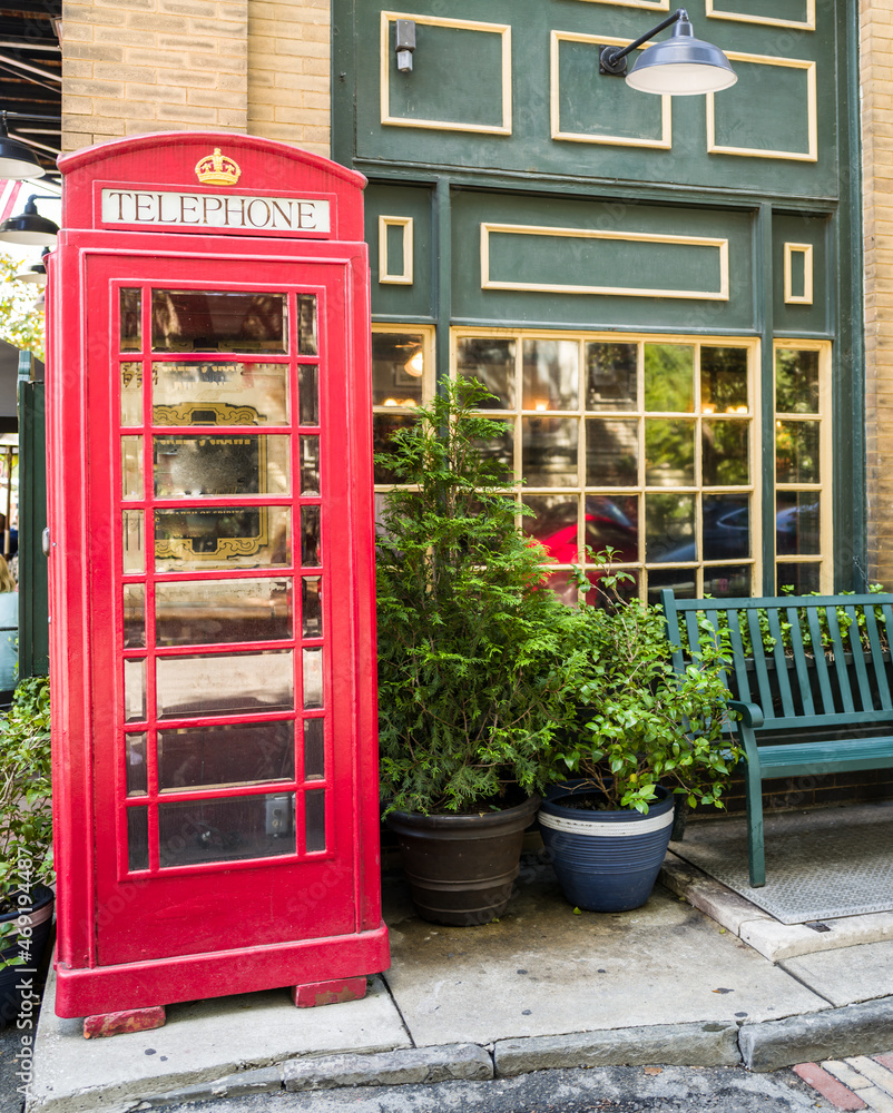 Fototapeta premium Vintage red telephone booth and bench