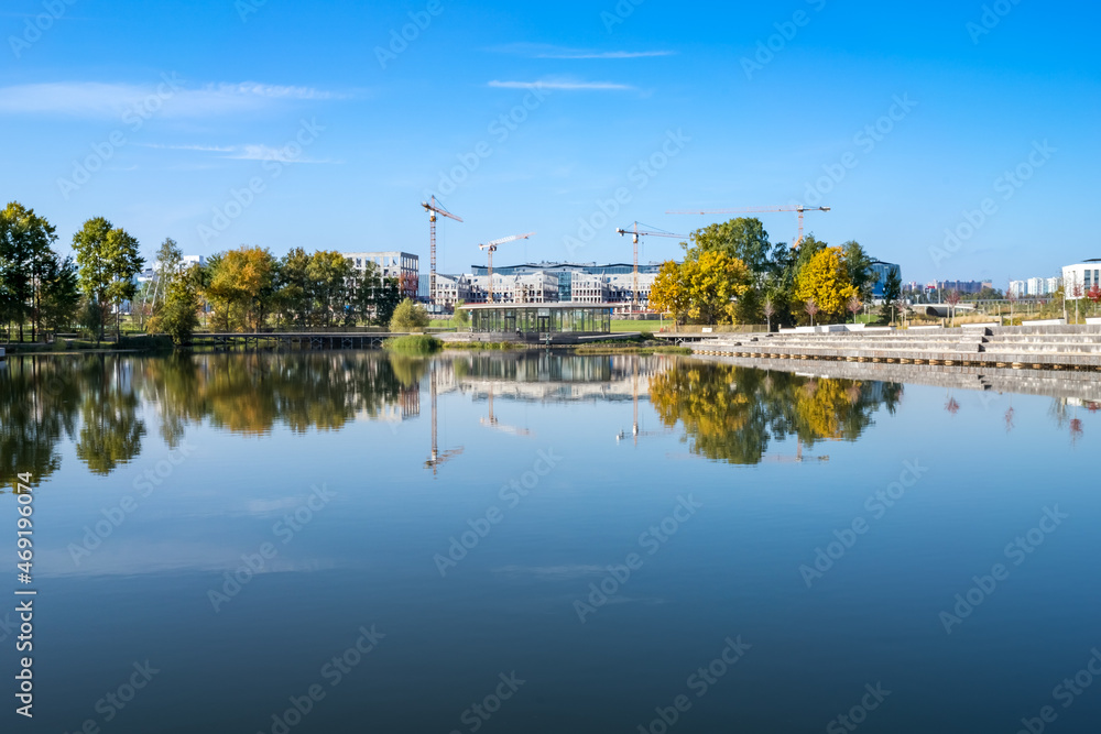Skolkovo Tsentral'nyy Park pond with reflection of construction site of the Skolkovo Innovation Center