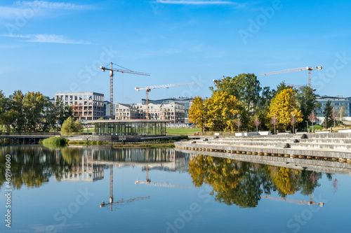 Photography Skolkovo Tsentral'nyy Park pond with reflection of construction site of the Skol