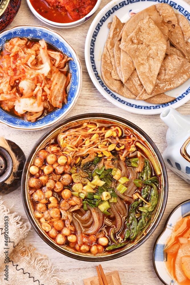 Hot and sour soup noodles on wood table Hot and sour soup noodles on wood table