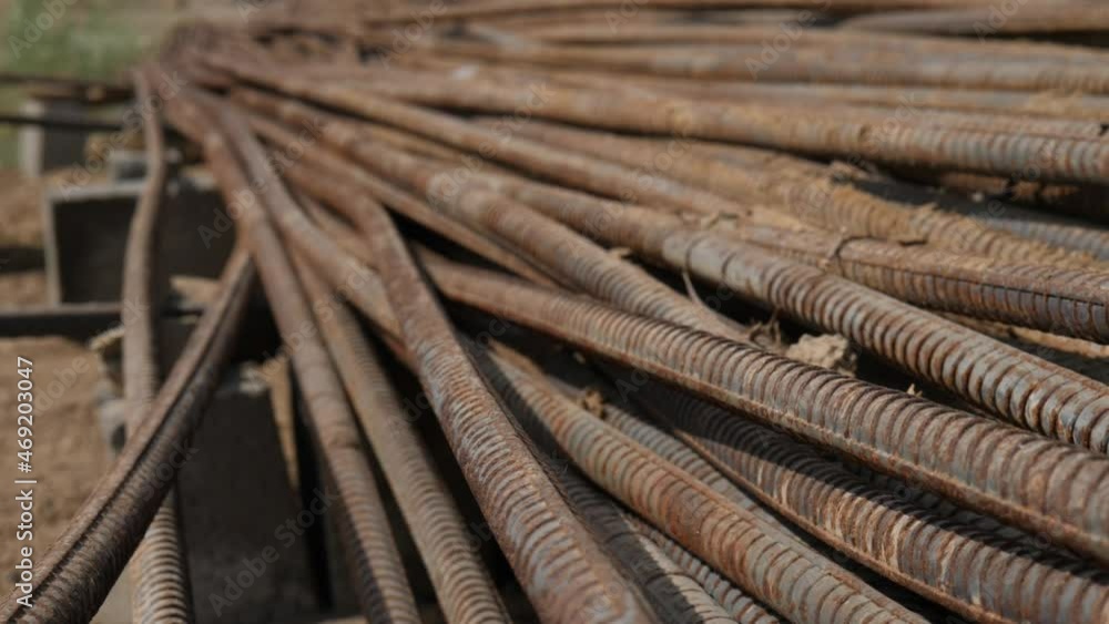Stack Of Rusty Metal Reinforcement Rods Laying On Ground. Close Up View Stack Of Rusty Metal Reinforcement Rods Laying On Ground. Close Up View