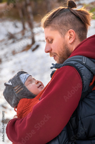 Close-up vertical lifestyle portrait of father an his baby son while walking outdoor