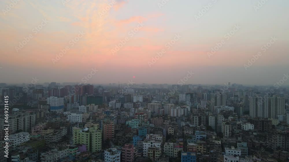 Drone flight over Dhaka during sunset; smoggy pollution Drone flight over Dhaka during sunset; smoggy pollution