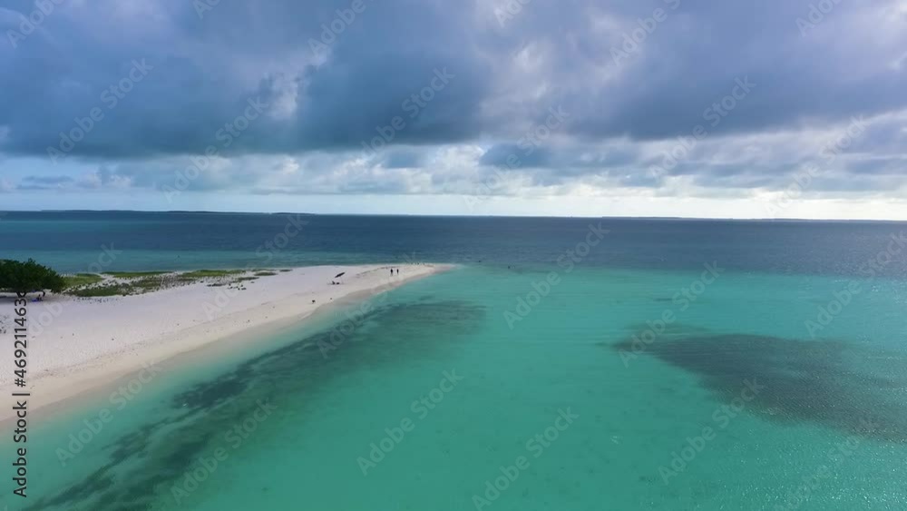 Birds and unrecognizable people walking on sand Caribbean beach madrisqui. Archipelago Aerial View Birds and unrecognizable people walking on sand Caribbean beach madrisqui. Archipelago Aerial View