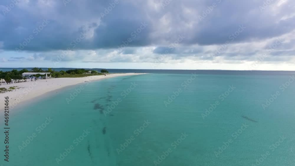 Aerial view forward motion heavenly Caribbean island with white sand beach and turquoise water Aerial view forward motion heavenly Caribbean island with white sand beach and turquoise water