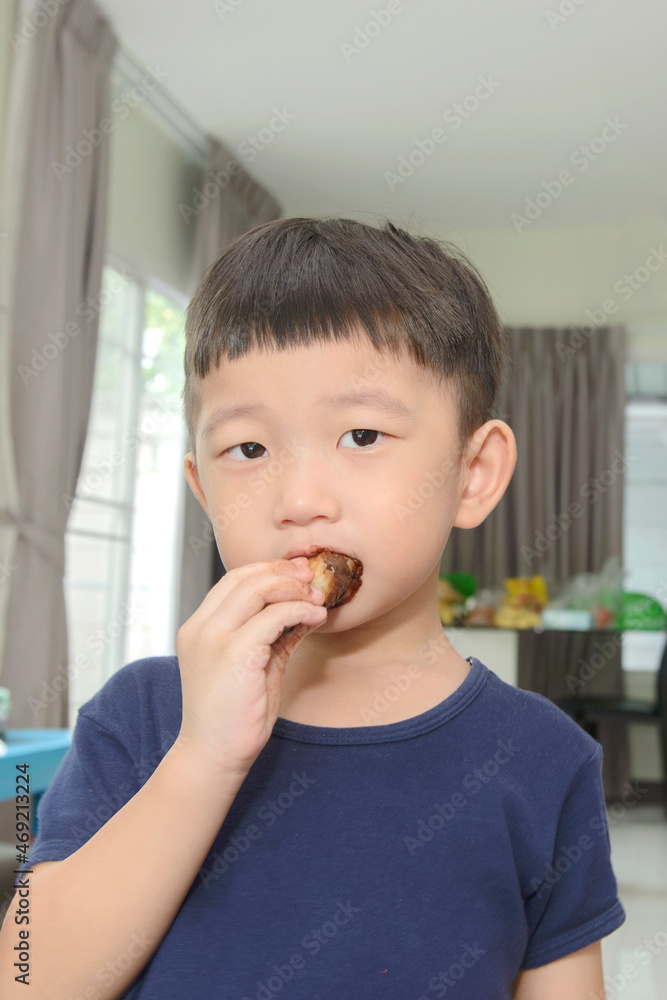 Little asian girl enjoying eating doughnut .Little girl having fun with doughnut. Little asian girl enjoying eating doughnut .Little girl having fun with doughnut.