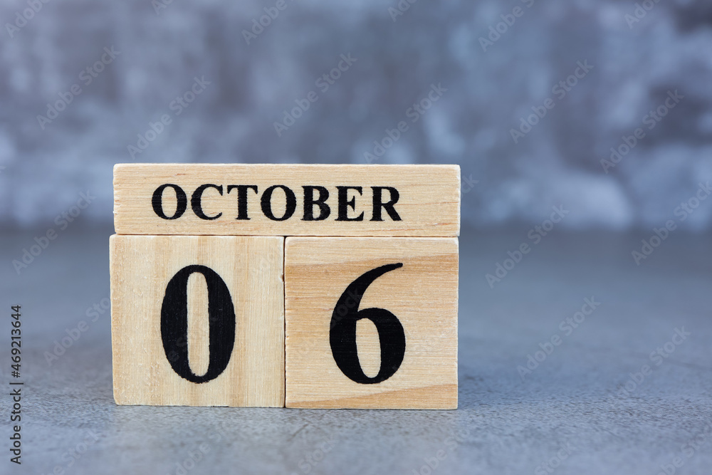 October 6th. Hello October, Cube wooden calendar showing date on 6 October, Wooden calendar with date on a dark background. October 6th. Hello October, Cube wooden calendar showing date on 6 October, Wooden calendar with date on a dark background.
