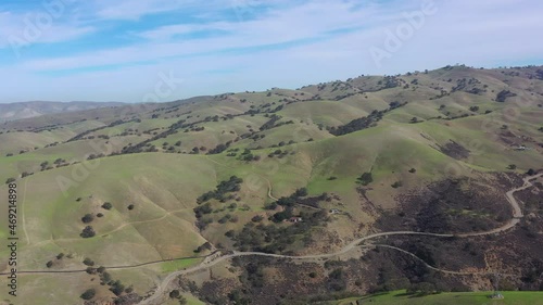 Green grass covers the scenic hills of Livermore, California. This beautiful region turns from brown to green during winter months due to much needed seasonal moisture. photo