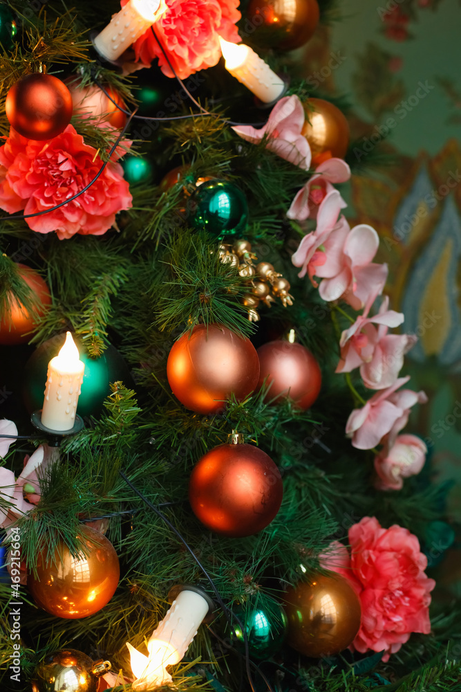 Fototapeta premium Decorative decorations on a festive Christmas tree. Bright New Year background. vertical frame