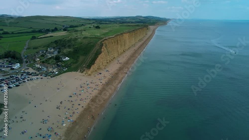 Wallpaper Mural Bridport West bay cliffs above British seaside turquoise ocean coastline aerial orbit right Torontodigital.ca