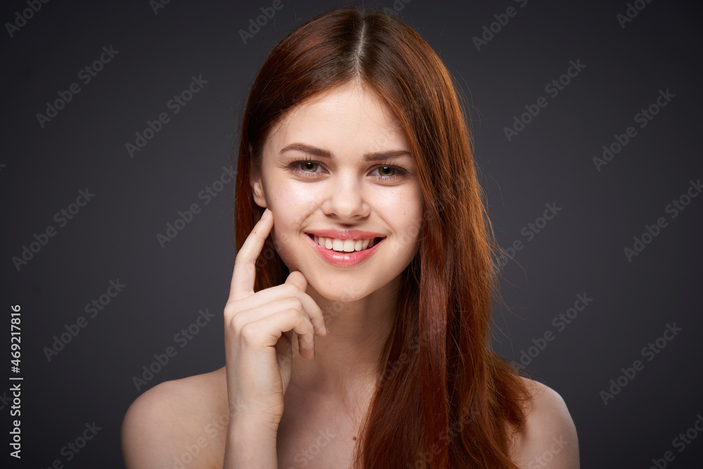 pretty red-haired woman naked shoulders posing dark background pretty red-haired woman naked shoulders posing dark background