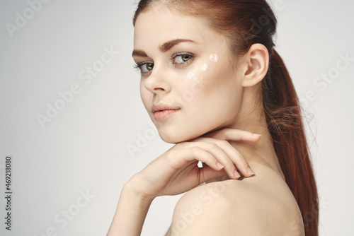 pretty red haired woman clean skin health posing light background