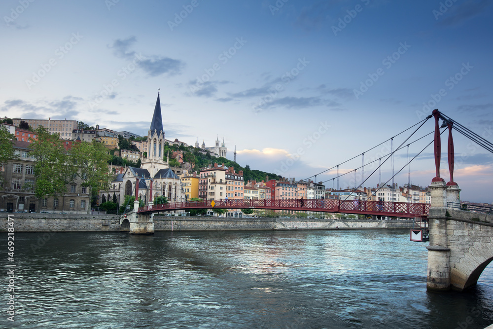 Footbridge and view of old city of Lyon before sunset, France