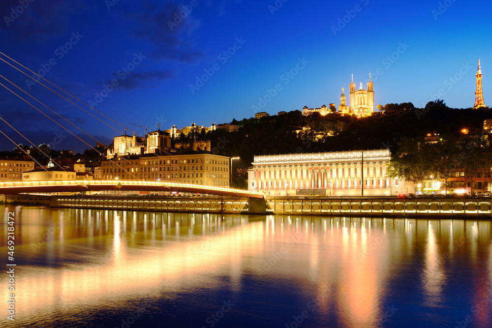 Footbridge, courthouse and basilica at Lyon city with citylights, France