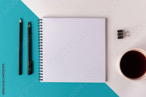 top view of an open notebook with blank pages next to a cup of coffee for adding text or layout