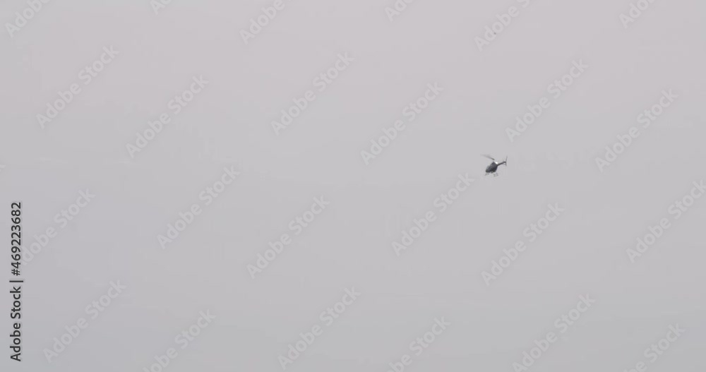 Tourist helicopter flying toward Castillo San Felipe del Morro with a blue sky background Tourist helicopter flying toward Castillo San Felipe del Morro with a blue sky background