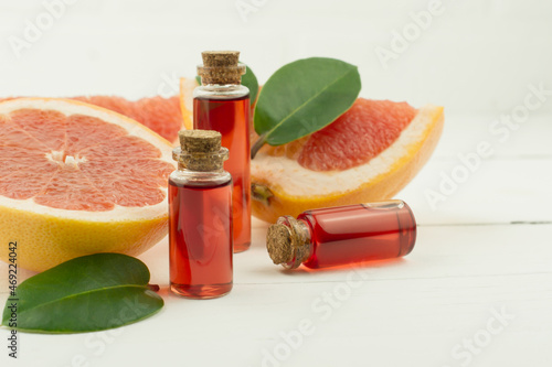 bottles with natural essence or grapefruit essential oil for self-care, aromatherapy, spa concept.