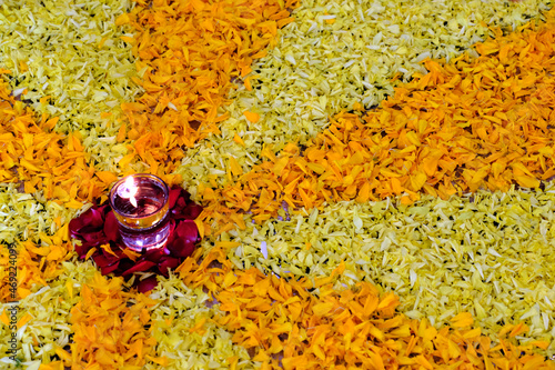 Diya flame on glass of water, flower rangoli design with diya, diwali festival of lights. photo