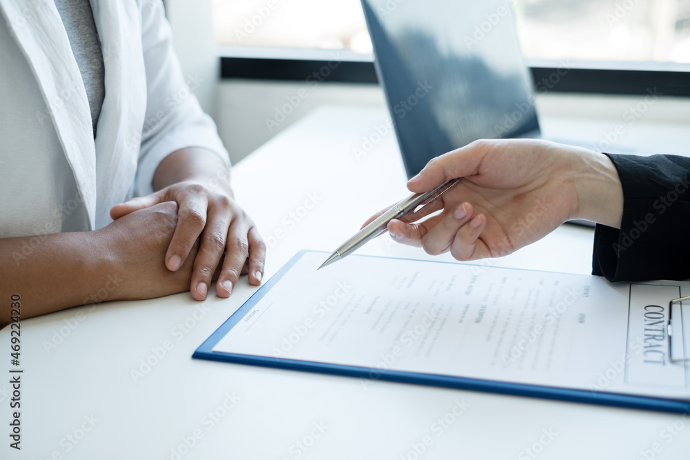A real estate agent with a House model is talking to clients about buying home insurance. Home insurance concept A real estate agent with a House model is talking to clients about buying home insurance. Home insurance concept