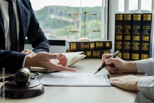 Fotografija Male lawyers or a judge counseling clients about judicial justice and prosecutio