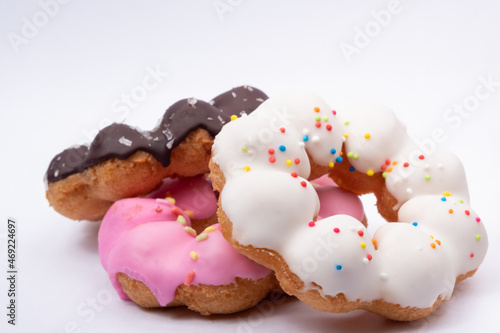 Three kinds of donuts have chocolate, white cream, pink cream on white background.