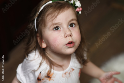 Little girl with curly hair, having fun while posing