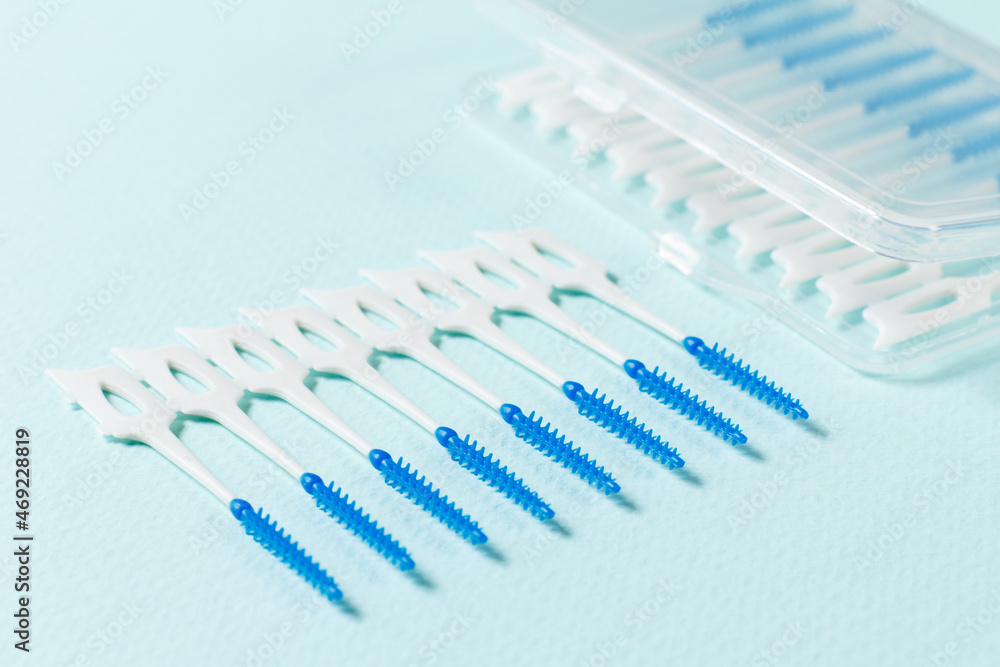 Close-up interdental brushes on the blue background Close-up interdental brushes on the blue background