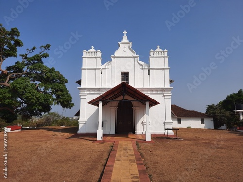 Three Kings church, goa church, Portuguese church in Goa. blue background with white church.