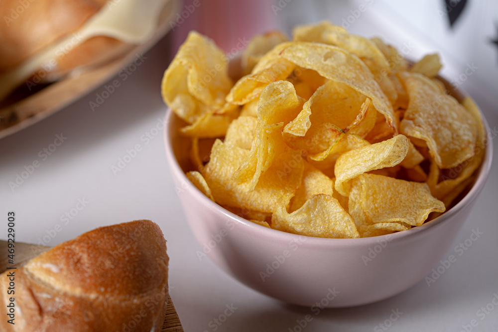 Yellow potato chips on a pink vase close up still on a catering food scene Yellow potato chips on a pink vase close up still on a catering food scene