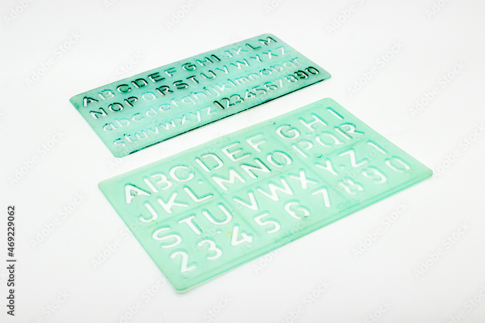 Alphabet stencils isolated on white background with selective focus Alphabet stencils isolated on white background with selective focus