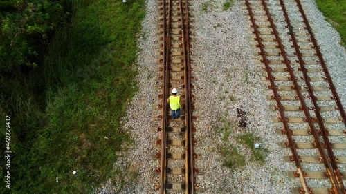 Arial view photo show engineer under inspection and checking construction process railway switch and checking work on railroad station .Engineer wearing safety uniform and safety helmet in 