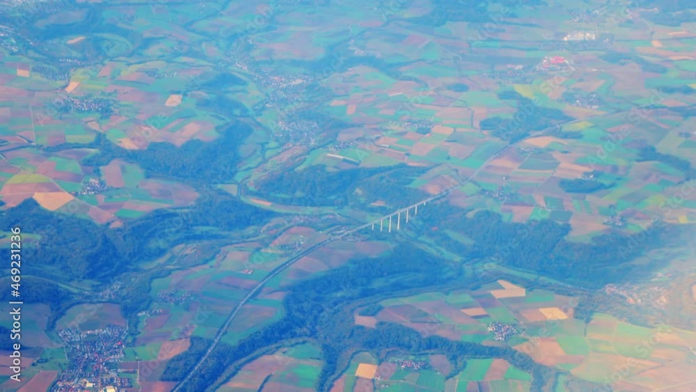 High up aerial view from plane of vast agricultural farm fields in rural Germany High up aerial view from plane of vast agricultural farm fields in rural Germany