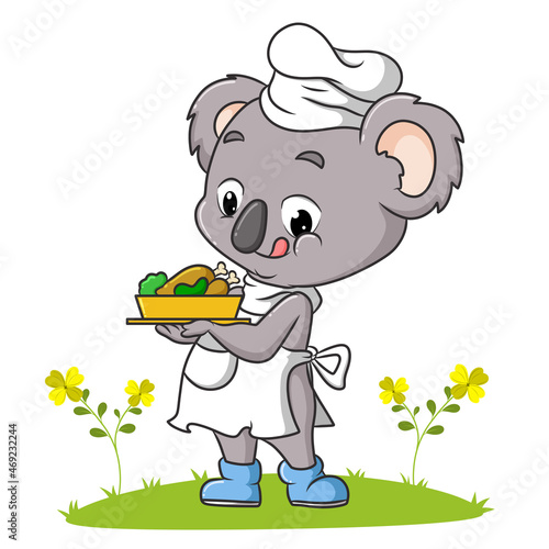 The koala chef is serving a chicken in the garden