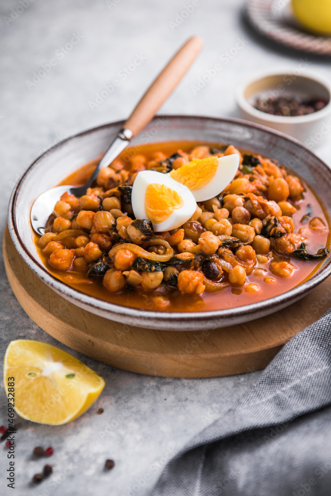 Fototapeta premium Potaje de vigilia - Chickpea stew with spinach and cod. Typical spanish food for Easter holidays.